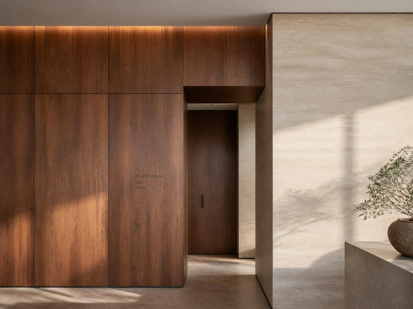Walnut architectural wall panels meeting a pale stone surface in a contemporary interior